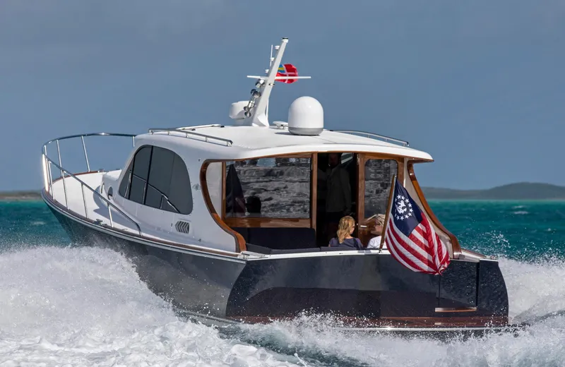 Slide: The Image of 2026 Palm Beach Motor Yachts PB45 cruising on turquoise waters with American flag. - 5