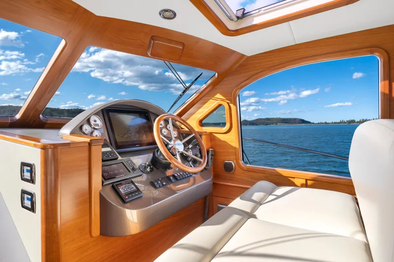 Slide: The Image of Helm of 2026 Palm Beach Motor Yachts PB45, featuring luxurious wood finish and scenic ocean view. - 6