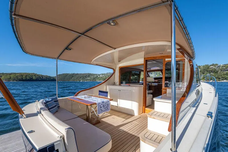 Slide: The Image of 2026 Palm Beach Motor Yachts PB45, elegant deck view, luxurious seating, scenic water backdrop. - 9