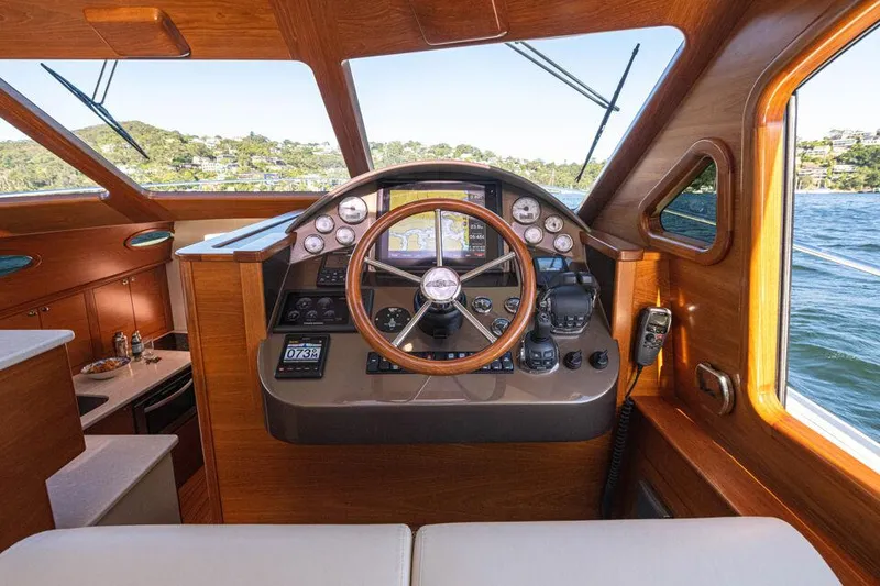 Slide: The Image of Helm of 2026 Palm Beach Motor Yachts PB45, featuring classic wood finish and modern controls. - 14
