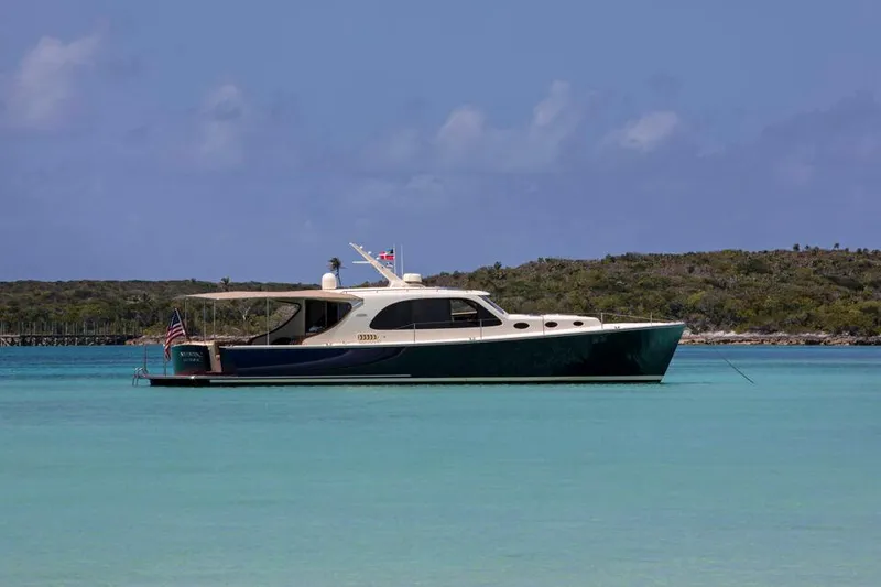 Slide: The Image of 2026 Palm Beach Motor Yachts PB50 cruising in clear turquoise waters. - 2
