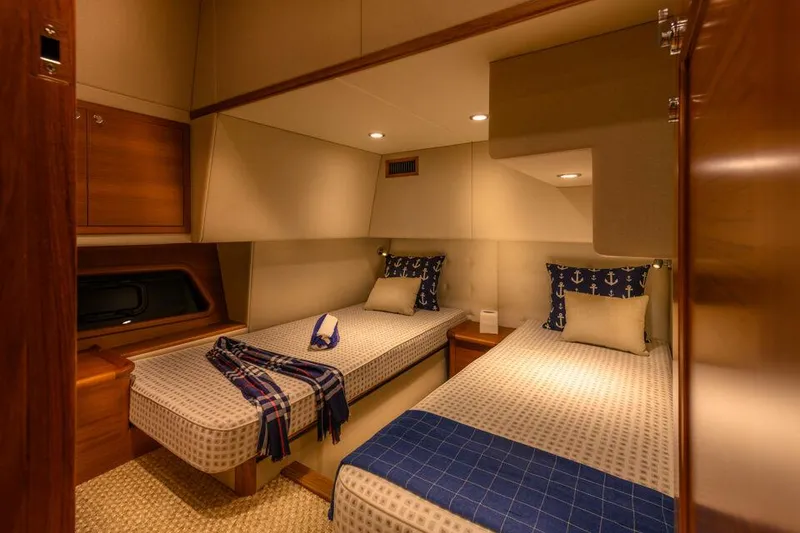 Slide: The Image of Luxurious twin cabin in 2026 Palm Beach Motor Yachts PB50, featuring elegant bedding and warm lighting. - 20