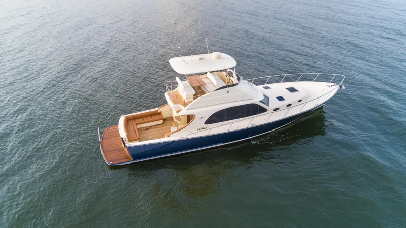 Slide: The Image of 2026 Palm Beach Motor Yachts PB50 cruising on open water, aerial view. - 24
