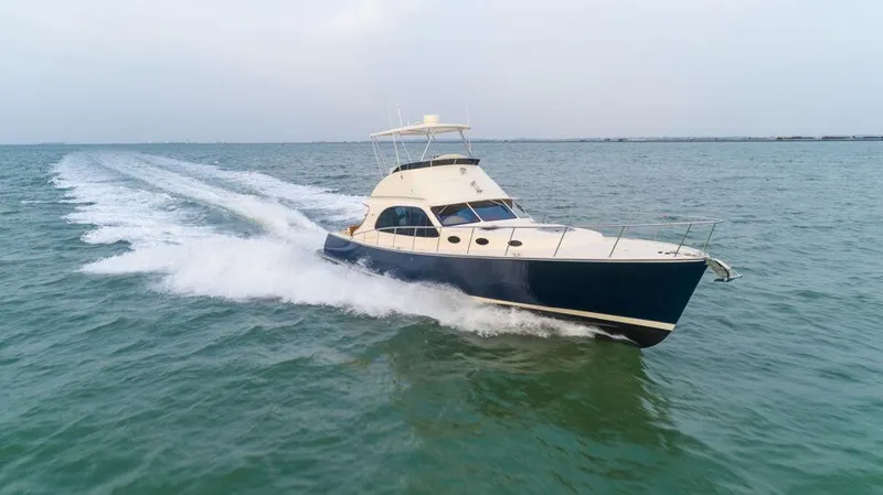 Slide: The Image of 2026 Palm Beach Motor Yachts PB50 cruising on open water. - 4