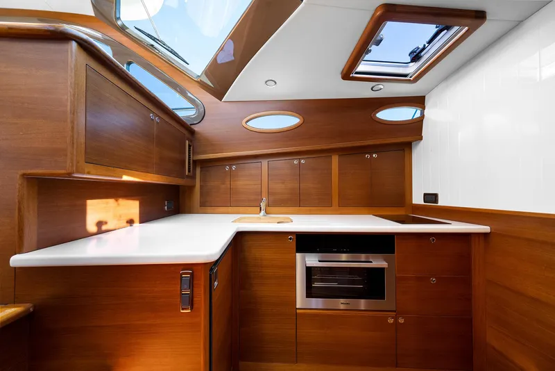 Slide: The Image of Luxurious 2026 Palm Beach Motor Yachts PB50 interior kitchen with wood cabinetry and modern appliances. - 21