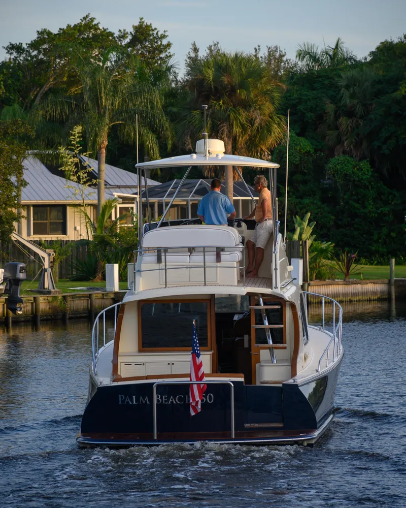 Slide: The Image of 2026 Palm Beach Motor Yachts PB50 cruising on a serene waterway. - 26