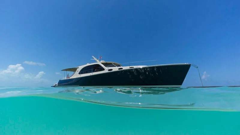 Slide: The Image of 2026 Palm Beach Motor Yachts PB50 on clear turquoise water under blue sky. - 27