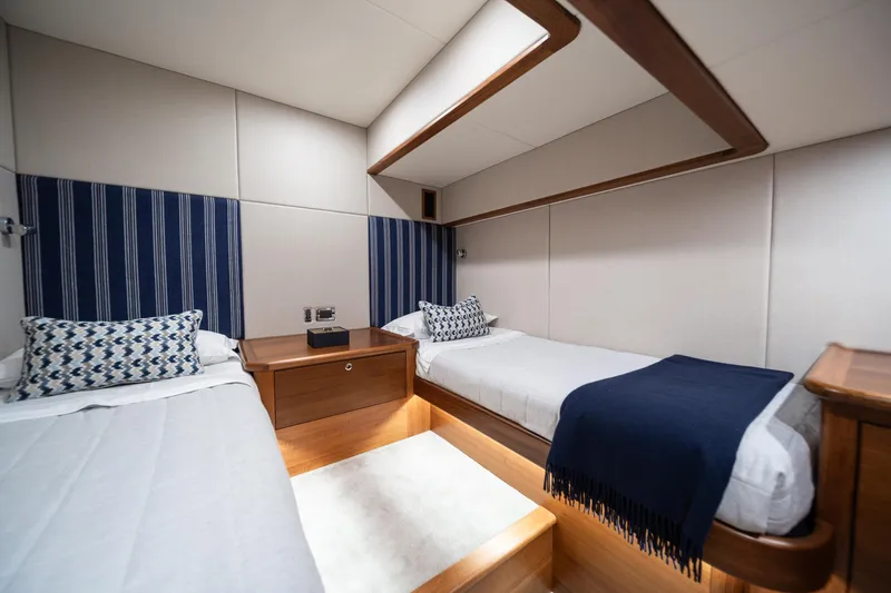 Slide: The Image of 2026 Palm Beach Motor Yachts PB70 cabin with twin beds and elegant decor. - 14