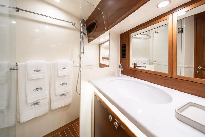 Slide: The Image of Luxurious bathroom in 2026 Palm Beach Motor Yachts PB70, featuring elegant wood accents and modern fixtures. - 18