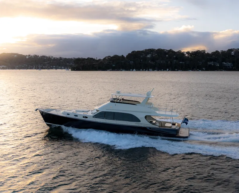 Slide: The Image of 2026 Palm Beach Motor Yachts PB70 cruising at sunset on serene waters. - 3