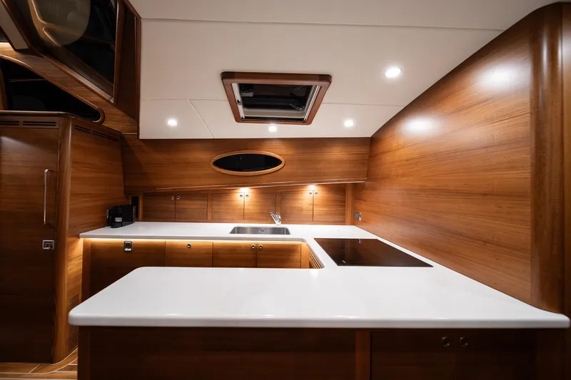 Slide: The Image of Luxurious kitchen interior of 2026 Palm Beach Motor Yachts PB70 with modern wood finish. - 8