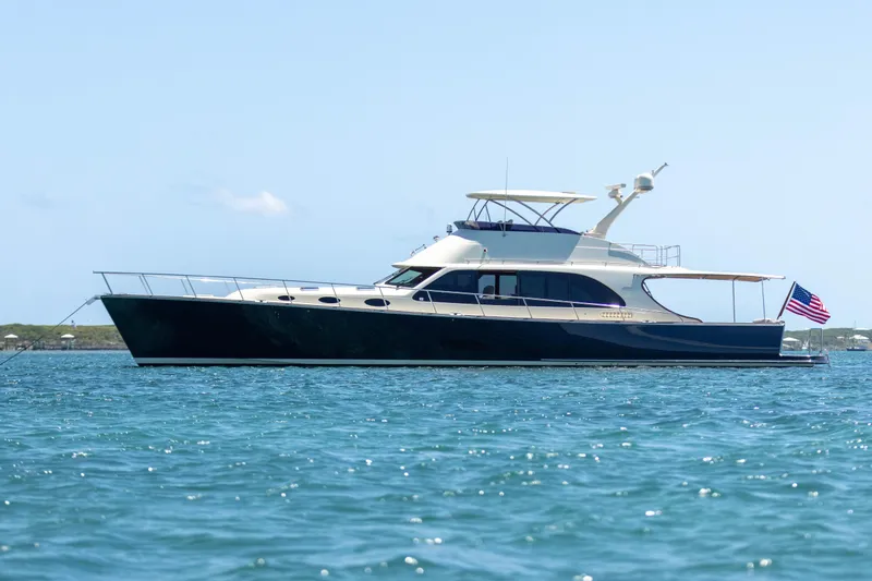 The Image of 2026 Palm Beach Motor Yachts PB70 cruising on open water, side view. - 0