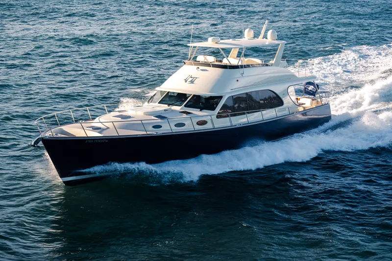 Slide: The Image of 2026 Palm Beach Motor Yachts PB70 cruising on open water. - 2