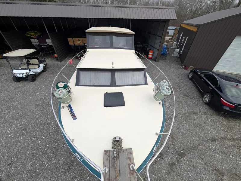The Image of 1989 Marinette 28 Sport Fish Fly Bridge boat in storage yard. - 1