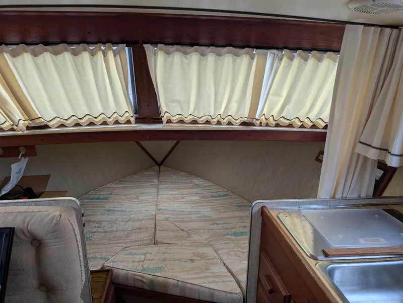 Slide: The Image of 1989 Marinette 28 Sport Fish Fly Bridge interior with cozy cabin and kitchenette. - 11
