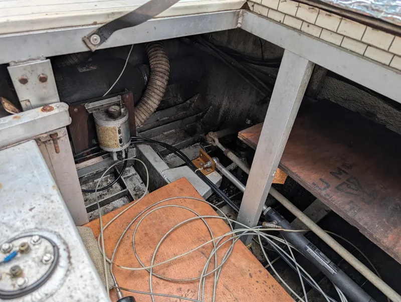 Slide: The Image of Engine compartment of 1989 Marinette 28 Sport Fish Fly Bridge with visible wiring and components. - 14