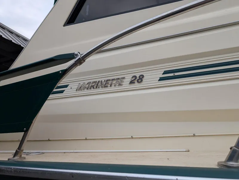 Slide: The Image of 1989 Marinette 28 Sport Fish Fly Bridge boat exterior with nameplate detail. - 18