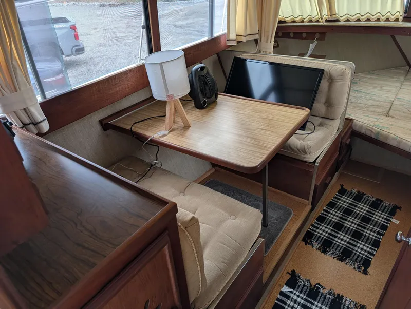 Slide: The Image of Interior of 1989 Marinette 28 Sport Fish Fly Bridge with table, seating, and lamp. - 22