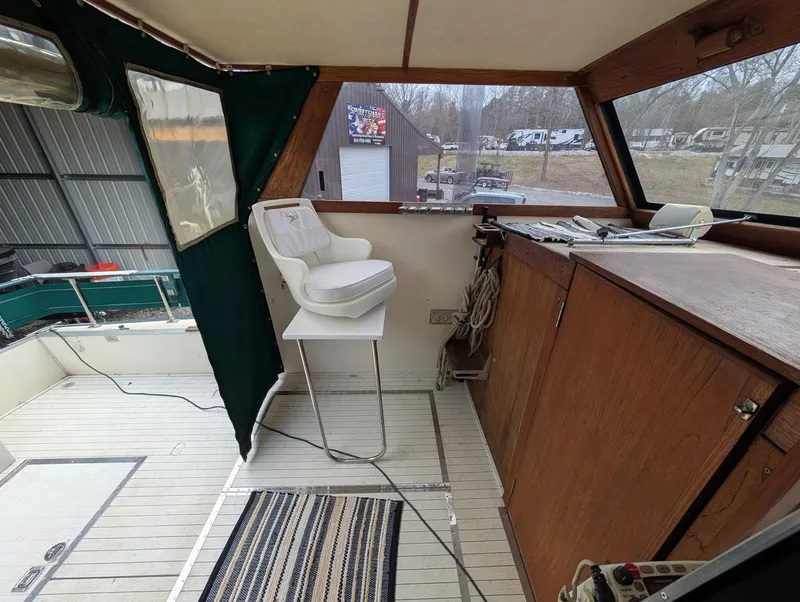 Slide: The Image of 1989 Marinette 28 Sport Fish Fly Bridge interior with captain's chair and control panel. - 7