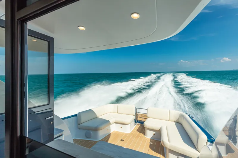 Slide: The Image of 2026 Palm Beach Motor Yachts GT50 cruising on open sea, featuring luxurious deck seating. - 8