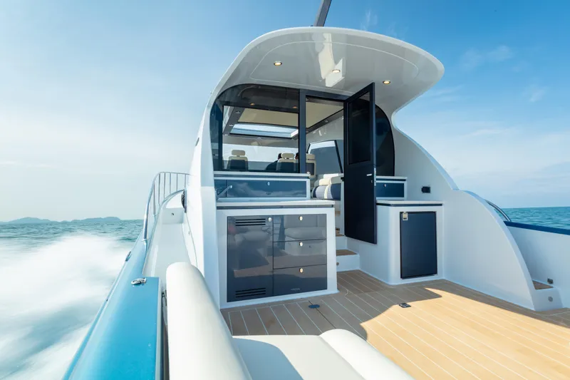 Slide: The Image of 2026 Palm Beach Motor Yachts GT50 cruising on open water, showcasing sleek design and luxury. - 13