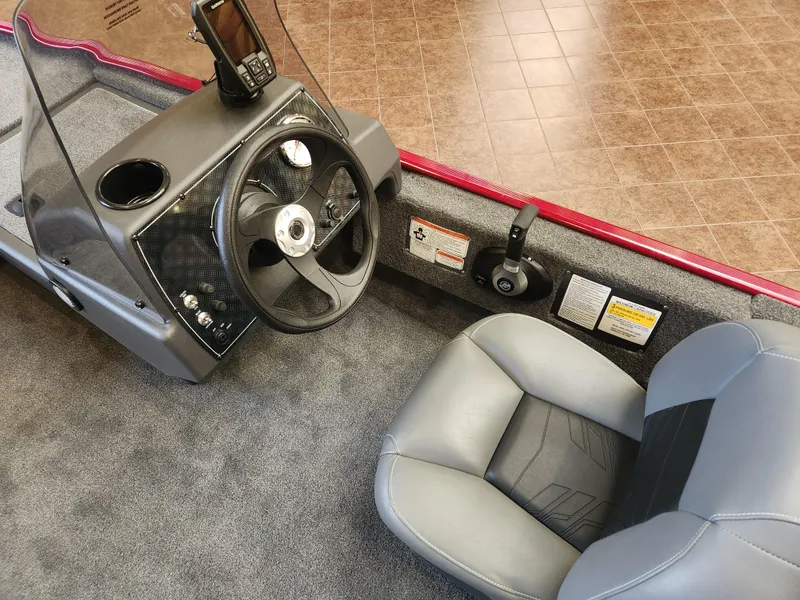 Slide: The Image of 2025 Tracker Bass Tracker Classic XL boat interior with steering wheel and seat. - 3