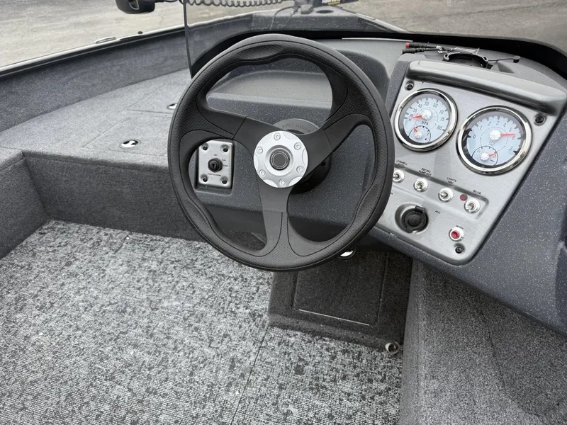 Slide: The Image of 2025 Tracker Pro Guide V-16 SC boat interior with steering wheel and dashboard gauges. - 10