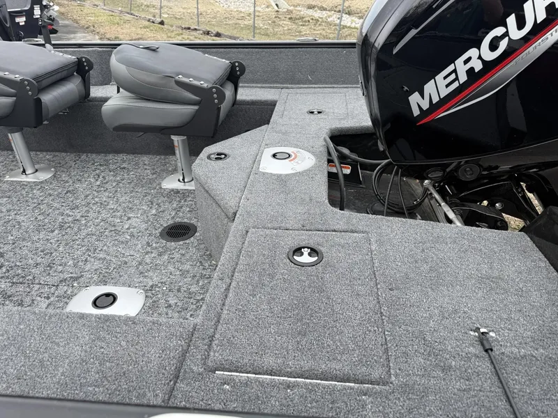 Slide: The Image of 2025 Tracker Pro Guide V-16 SC boat interior with Mercury engine, featuring seating and storage. - 3