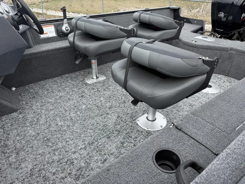 Slide: The Image of 2025 Tracker Pro Guide V-16 SC boat interior with gray seating and carpeted flooring. - 5