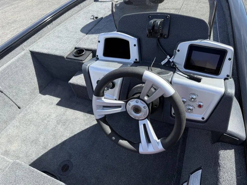 Slide: The Image of 2025 Tracker Pro Team 190 boat dashboard with steering wheel and control panels. - 12