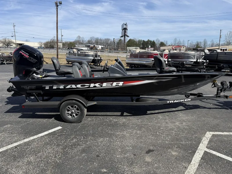 Slide: The Image of 2025 Tracker Pro Team 190 boat on trailer in parking lot. - 2