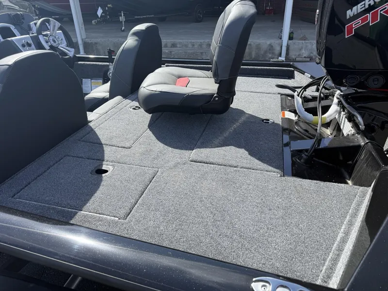 Slide: The Image of 2025 Tracker Pro Team 190 boat interior with cushioned seating and storage compartments. - 4