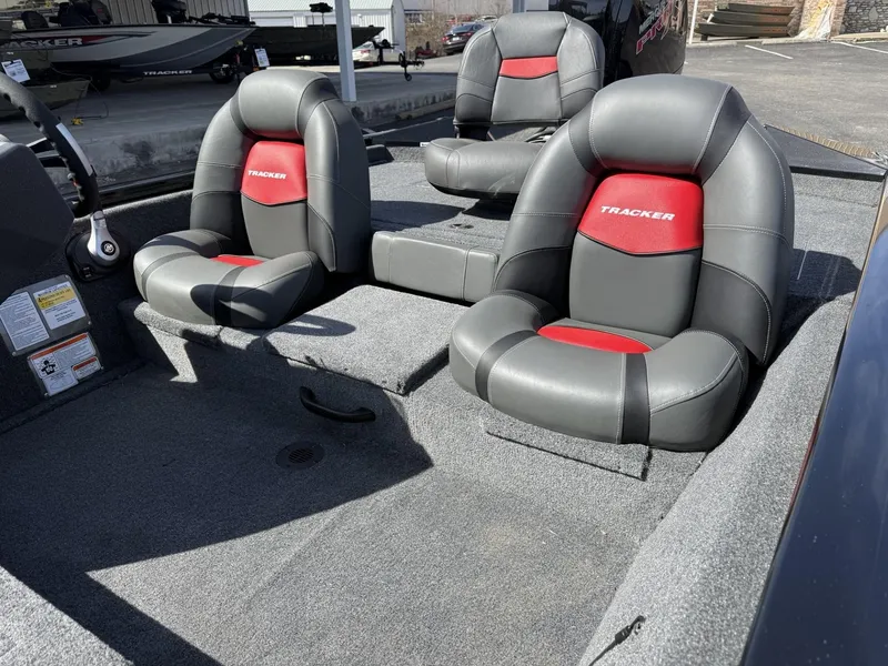 Slide: The Image of 2025 Tracker Pro Team 190 boat interior with gray and red seating. - 6
