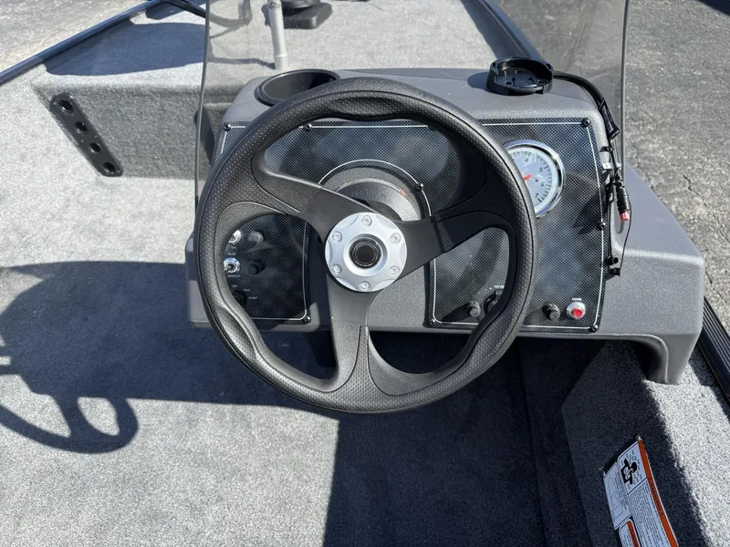 Slide: The Image of Steering wheel of 2025 Tracker Bass Tracker Classic XL boat, featuring a simple dashboard design. - 10