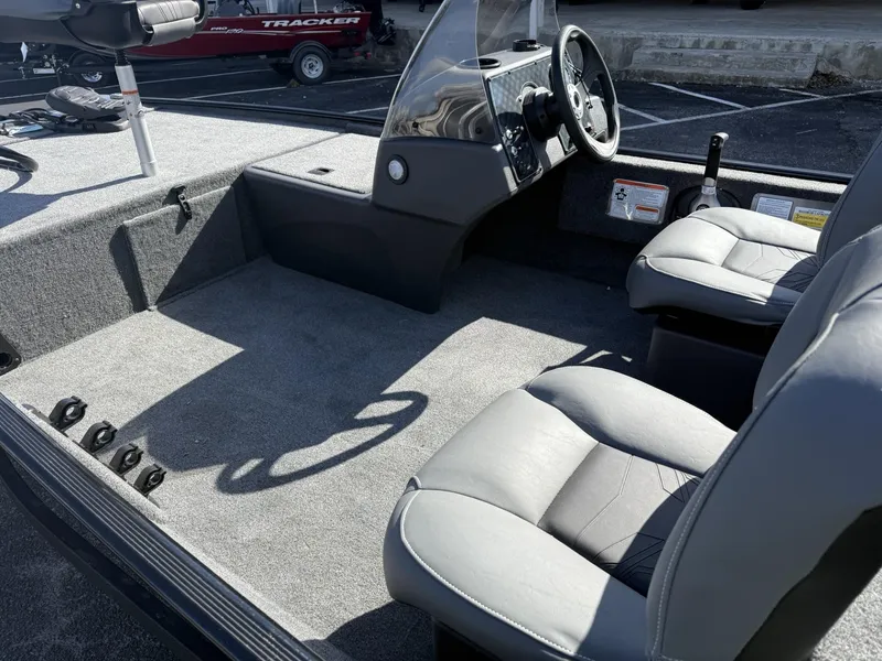 Slide: The Image of 2025 Tracker Bass Tracker Classic XL interior with gray seating and steering console. - 5