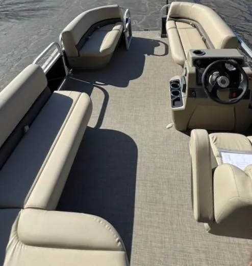 Slide: The Image of 2025 Sun Tracker Party Barge 16 DLX pontoon boat with spacious seating and steering console. - 8