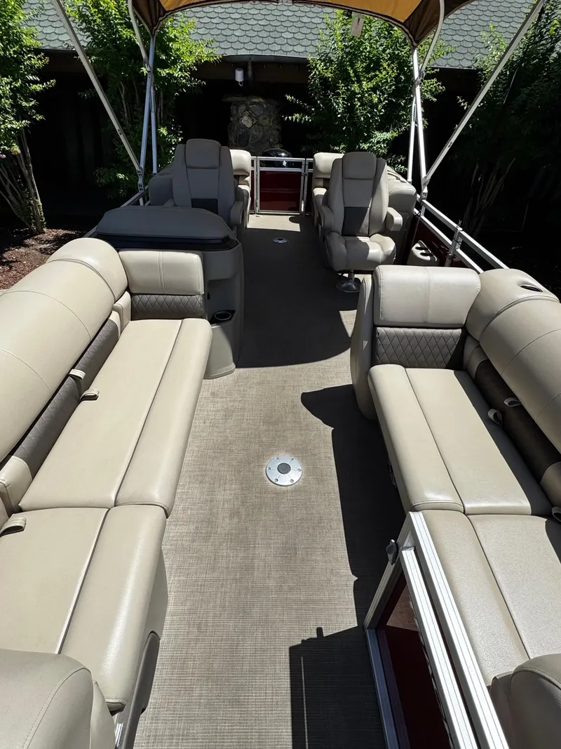 Slide: The Image of 2025 Sun Tracker Party Barge 22 DLX interior with spacious seating and canopy. - 4