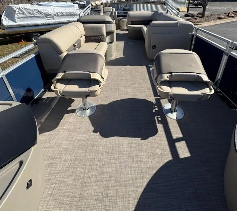 Slide: The Image of 2025 Sun Tracker Fishin' Barge 20 DLX interior with spacious seating and fishing chairs. - 7