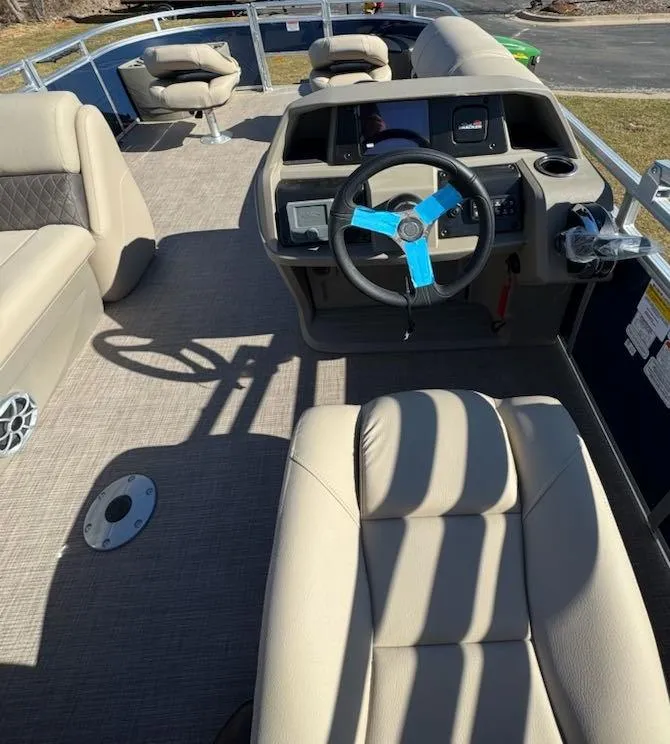 Slide: The Image of 2025 Sun Tracker Fishin' Barge 20 DLX interior with steering wheel and seating. - 9