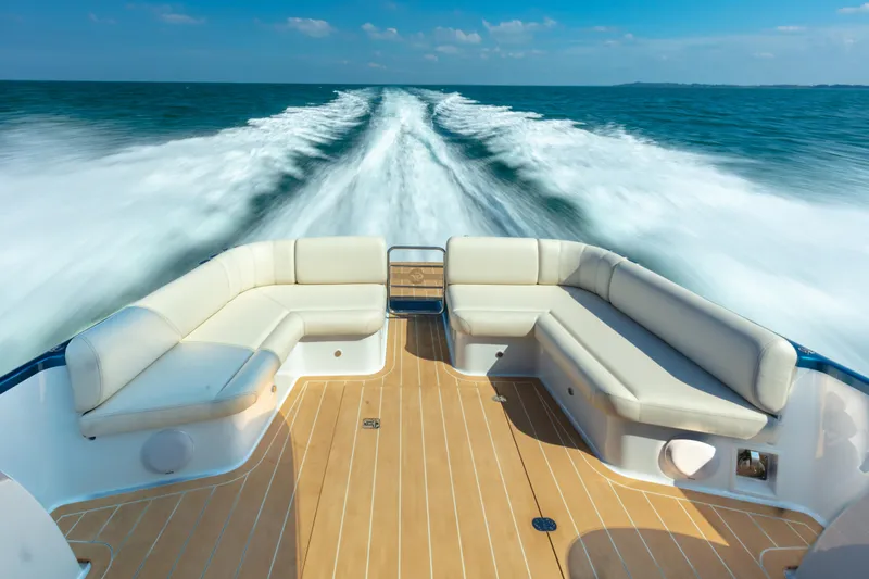 Slide: The Image of 2026 Palm Beach Motor Yachts GT50 cruising on open water, featuring elegant deck seating. - 5