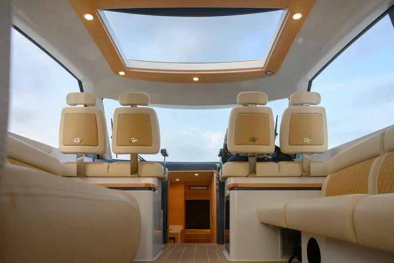 Slide: The Image of Interior of 2026 Palm Beach Motor Yachts GT50, featuring luxurious seating and panoramic sunroof. - 9