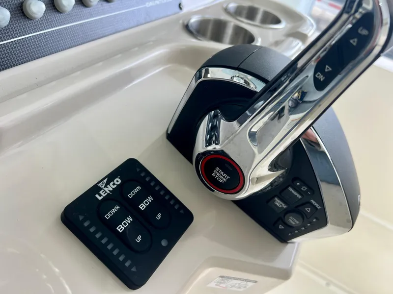 Slide: The Image of Boston Whaler 250 Dauntless 2025 boat controls with Lenco trim tab switches. - 14