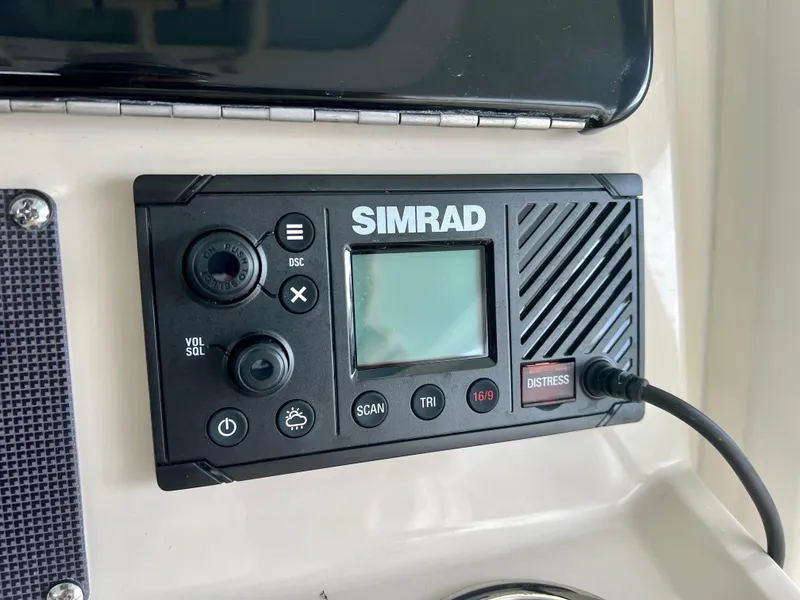 Slide: The Image of Simrad marine radio on 2025 Boston Whaler 250 Dauntless dashboard. - 15