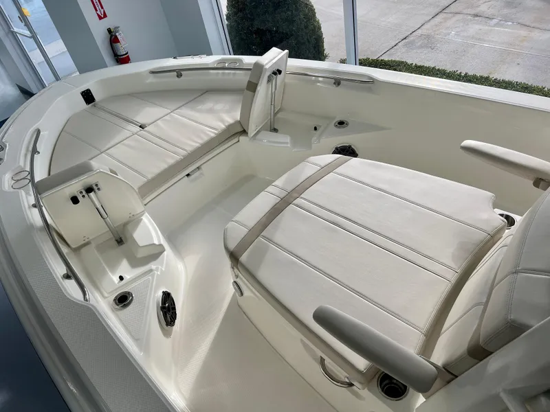 Slide: The Image of 2025 Boston Whaler 250 Dauntless boat interior with cushioned seating and sleek design. - 17