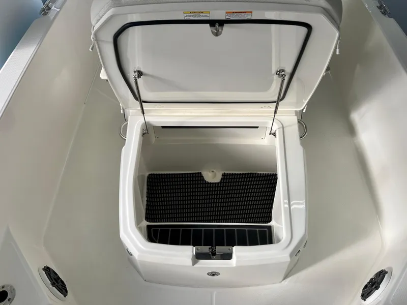 Slide: The Image of 2025 Boston Whaler 250 Dauntless storage compartment, open lid, spacious interior design. - 18