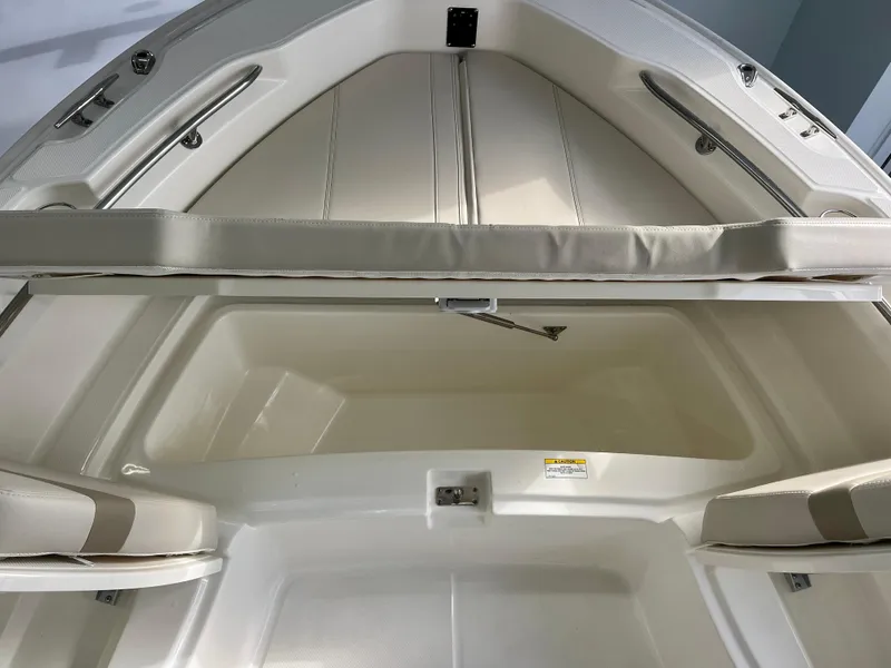 Slide: The Image of 2025 Boston Whaler 250 Dauntless boat interior, featuring spacious seating and storage area. - 19