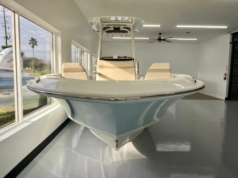 Slide: The Image of 2025 Boston Whaler 250 Dauntless boat in showroom, front view, sleek design. - 3
