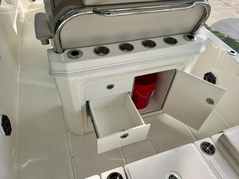 Slide: The Image of 2025 Boston Whaler 250 Dauntless boat interior with storage compartments and rod holders. - 8