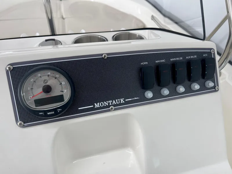 Slide: The Image of Control panel of 2025 Boston Whaler 170 Montauk boat with gauges and switches. - 10