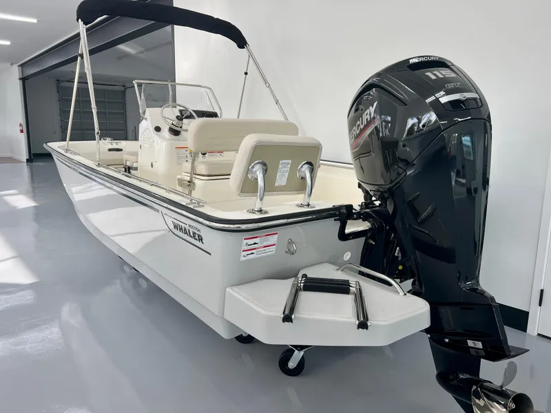Slide: The Image of 2025 Boston Whaler 170 Montauk boat with Mercury outboard engine in showroom. - 4